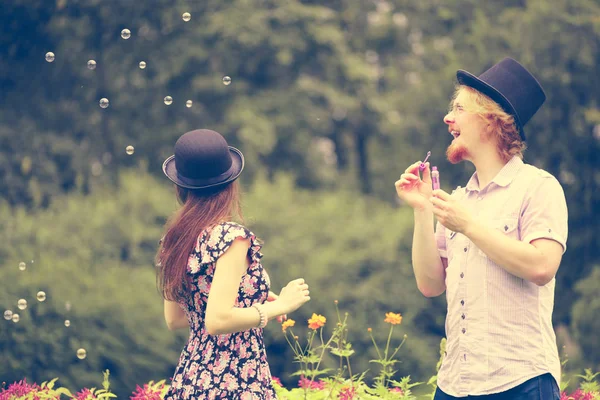 Feliz Divertido Hipster Pareja Jugando Juntos Soplando Jabón Burbujas Aire — Foto de Stock