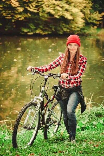 Fall active lifestyle concept. Beauty young woman sporty casual girl relaxing in autumnal park with bicycle, outdoor