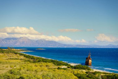 Greek coastline with the famous rusty shipwreck Dimitrios in Glyfada beach near Gytheio, Gythio Laconia Peloponnese Greece. clipart