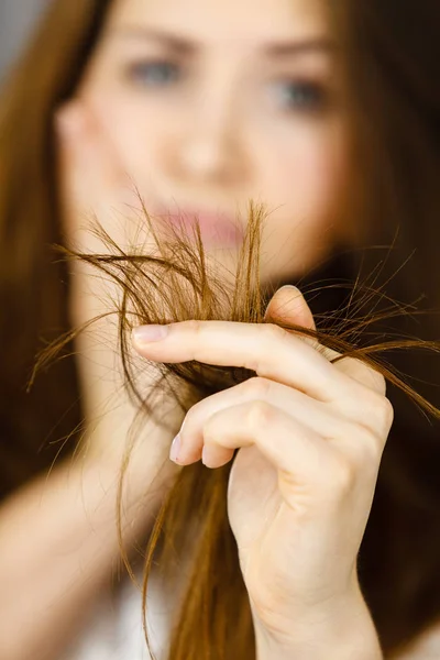 担心的女人正看着她干开叉长长的褐色头发 思考的很好的治疗 护发和发型设计概念 — 图库照片