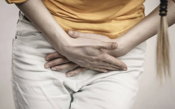 Closeup young sick woman with hands holding pressing her crotch lower abdomen. Medical or gynecological problems, healthcare concept — Stock Image Closeup Young Sick Woman Hands Holding Pressing Her Crotch Lower Stock Photo