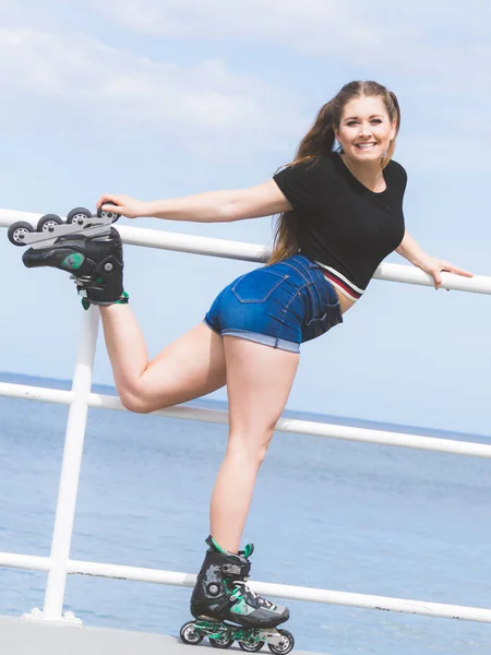 乗車後にリラックスしたローラースケートを身に着けている魅力的な若い女性 海の海岸で夏の時間の間に楽しんでいる女性にフィット — ストック写真