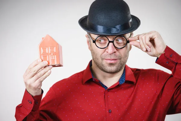 Adult Man Wearing Funny Hat Eyeglasses Holding Small Red House — Stock Photo, Image
