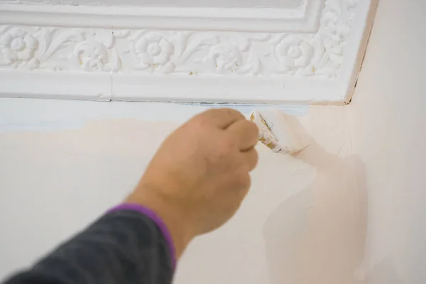 Person Appplying White Paint Blue Wall Using Brush Home Renovation — Stock Photo, Image