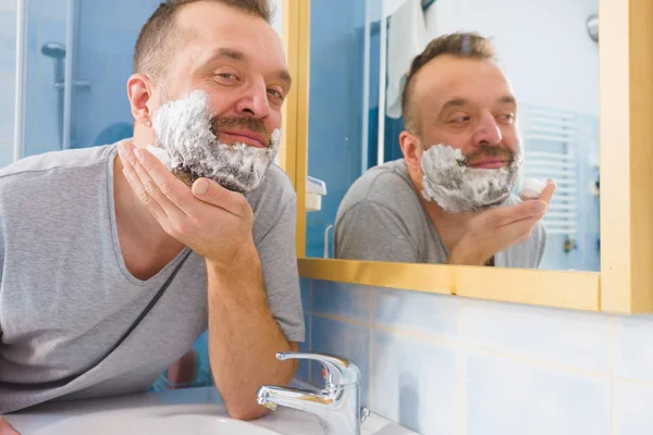 Man Applying Shaving Foam Cream His Face Standing Bathroom Looking — Stock Photo, Image