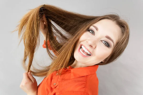 Happy Funny Teenage Woman Combing Her Long Brown Hair Showing Royalty Free Stock Images