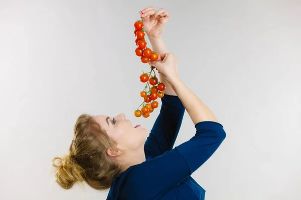 Woman holding fresh cherry tomatoes — Stock Photo, Image