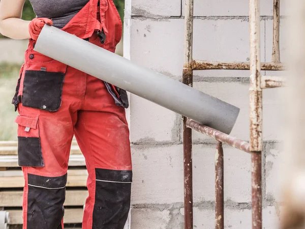 Femme Dungarees Portant Des Tuyaux Plastique Sur Son Site Construction — Photo