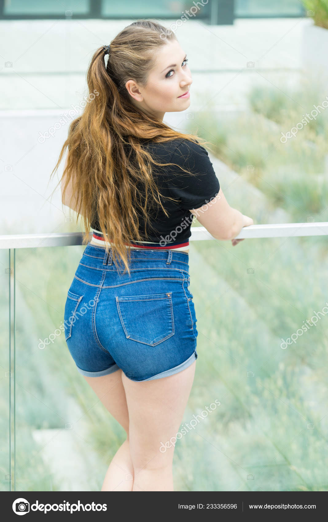 Back View Young Teenage Woman Wearing Short Blue Jeans Denim Stock Photo by  ©Voyagerix 233356596
