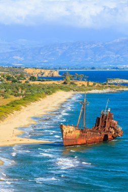 Greek coastline with the famous rusty shipwreck Dimitrios in Glyfada beach near Gytheio, Gythio Laconia Peloponnese Greece. View from distance. clipart