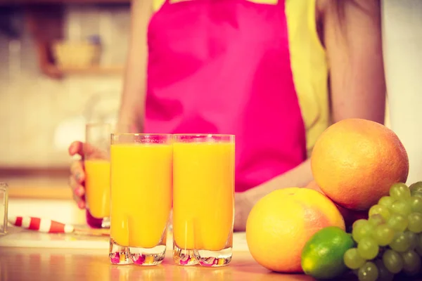 新鮮なオレンジ ジュースを作って台所で女性若い主婦 健康的な食事 ベジタリアン食品 ダイエットや人 — ストック写真