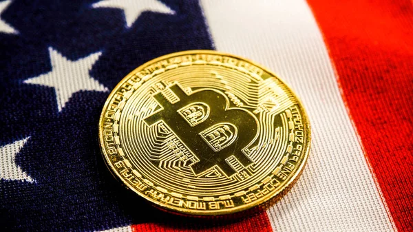 Crypto currency bitcoin btc golden bit coin against flag of United States of America USA. Virtual money, blockchain business, internet finances concept.