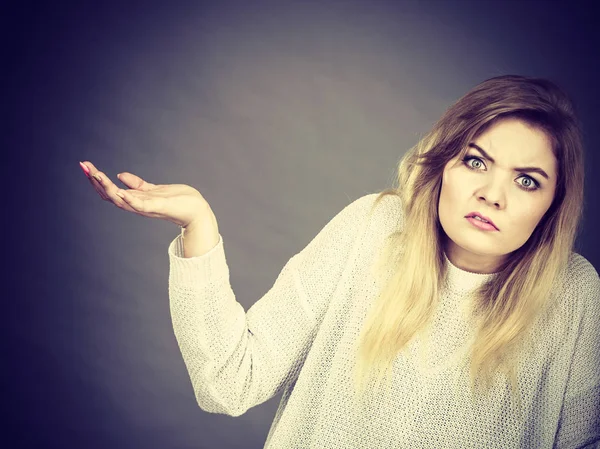 Confused young blonde woman gesturing with hands — Stock Photo, Image