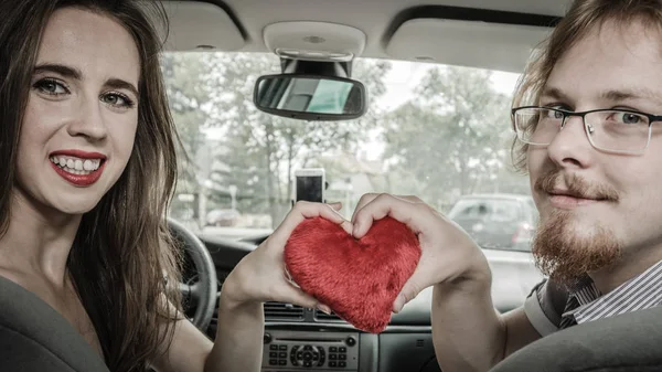 Man and woman showing love in car — Stock Photo, Image