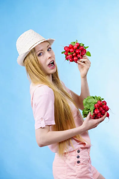 Young woman holding radish — Stock Photo, Image