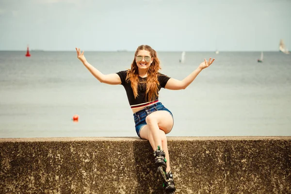 Happy young woman wearing roller skates — Stock Photo, Image