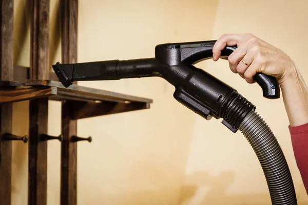 Woman cleaning dust on hanger — Stock Photo, Image