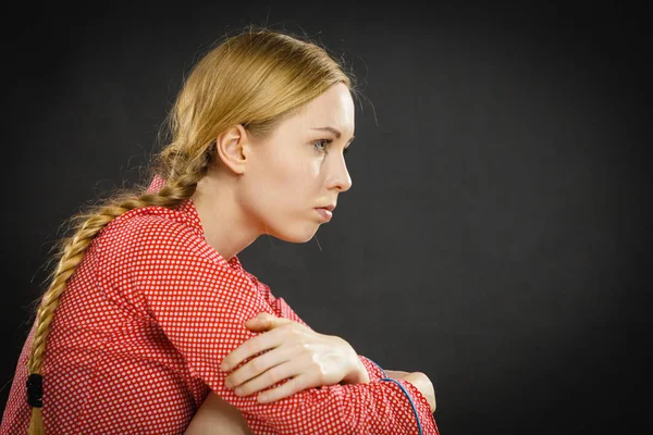 Smutné, depresivní dívka sedí schoulená — Stock fotografie