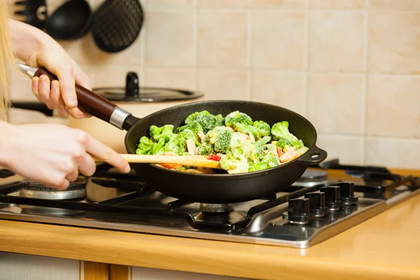 Жінка готує перемішайте заморожений овоч на сковороді — стокове фото