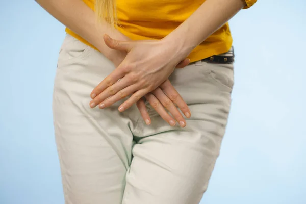 Woman with hands holding her crotch — Stock Image Woman with hands holding her crotch Royalty Free Stock Photos