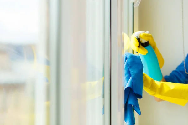 Hand cleaning window at home using detergent rag — Stock Photo, Image