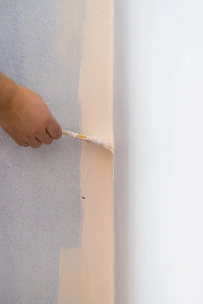 Person applying paint on wall — Stock Photo, Image