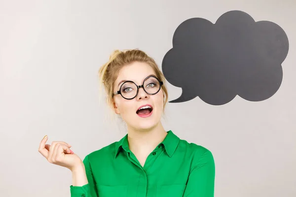 Woman holding black thinking bubble — Stock Photo, Image