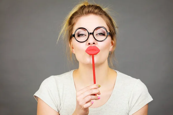 Happy woman holding fake lips on stick — Stock Photo, Image