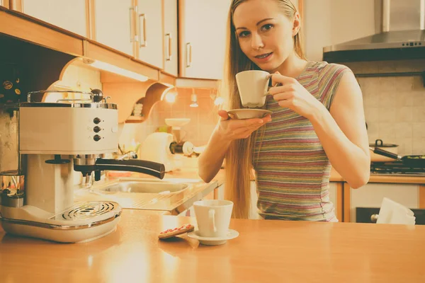 Woman in kitchen making coffee from machine — Stock Photo, Image