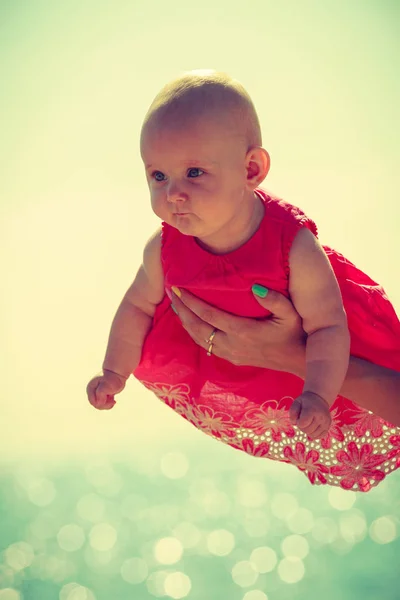 Little baby held by mother sunny day. — Stock Photo, Image