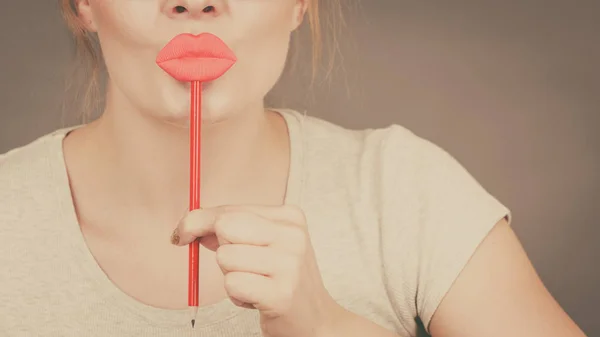 Happy woman holding fake lips on stick — Stock Photo, Image