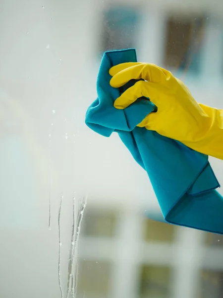 Hand cleaning window at home using detergent rag — Stock Photo, Image