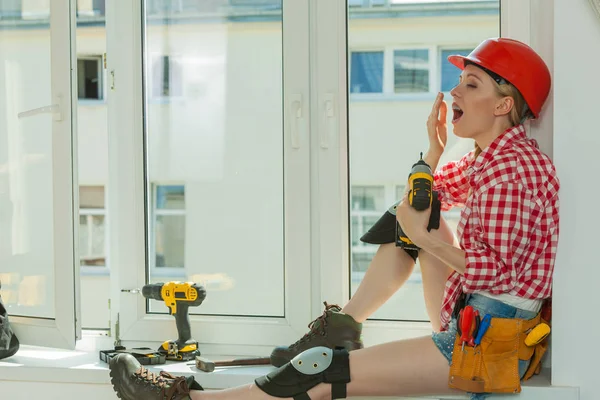 Bored woman with helmet next to the window — Stock Photo, Image