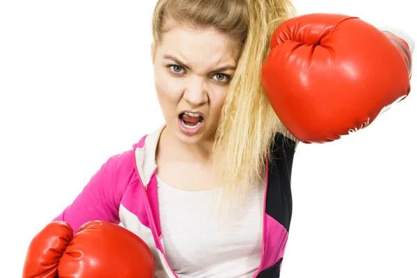 Angry woman wearing boxing gloves — Stock Photo, Image