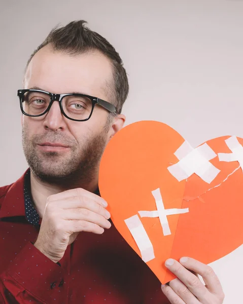 Sad adult man holding broken heart — Stock Photo, Image