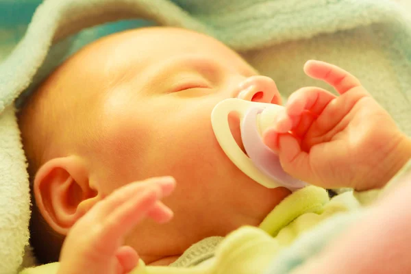 Closeup of little newborn sleeping with teat in mouth — Stock Photo, Image