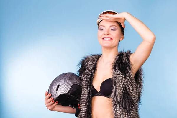 Woman wearing bra, holding ski helmet, looking up — Stock Photo, Image