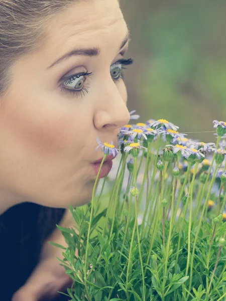 Frau riecht Blumen — Stockfoto