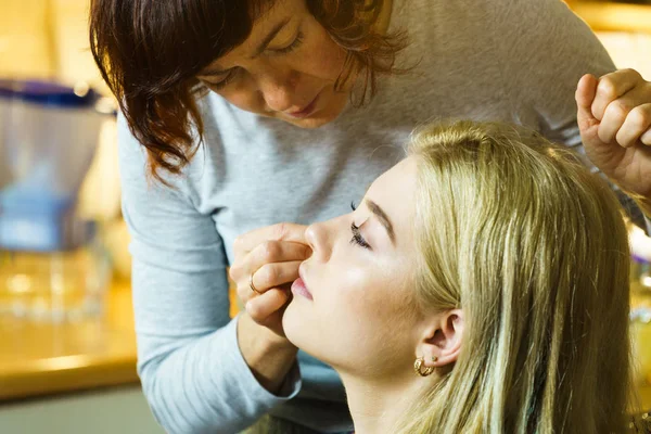 Woman getting make up from artist — Stock Photo, Image