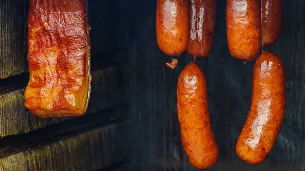 Smoked sausages meat hanging in smokehouse — Stock Photo, Image