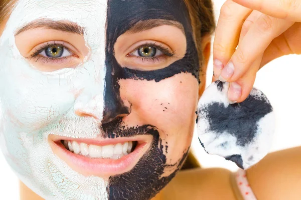 Girl remove black white mud mask from face — Stock Photo, Image