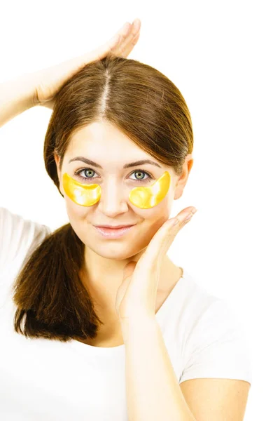 Woman with gold patches under eyes — Stock Photo, Image