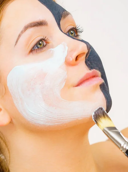 Girl black mask on half face apply white mud — Stock Photo, Image