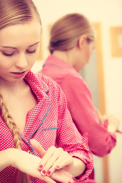 Woman applying hand cream on hands — Stock Photo, Image