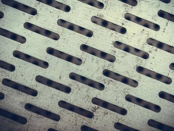 Primer plano abstracto de la textura de acero con agujeros — Foto de Stock