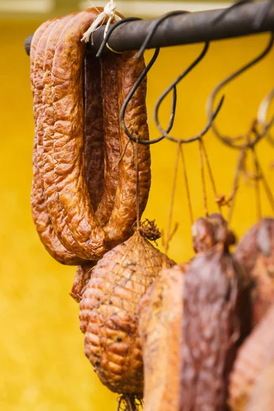 Smoked sausages meat hanging in smokehouse — Stock Photo, Image