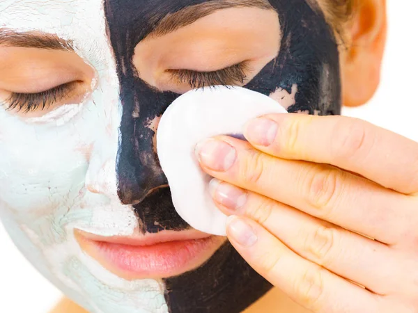 Girl remove black white mud mask from face — Stock Photo, Image