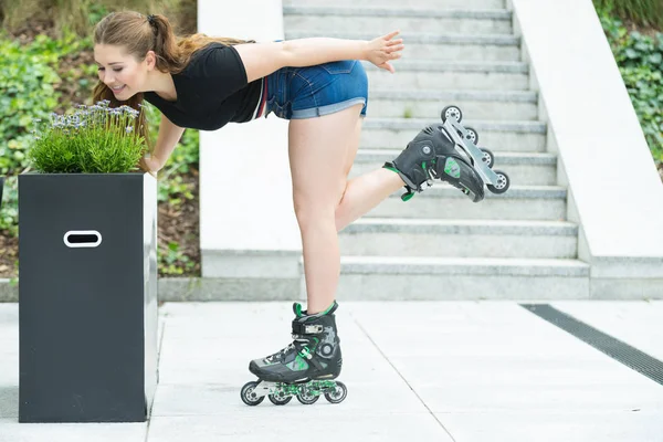 Young woman riding roller skates — Stock Photo, Image