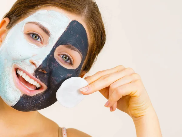 Girl remove black white mud mask from face — Stock Photo, Image