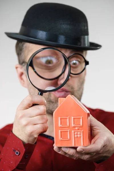 Man magnifying red house — Stock Photo, Image